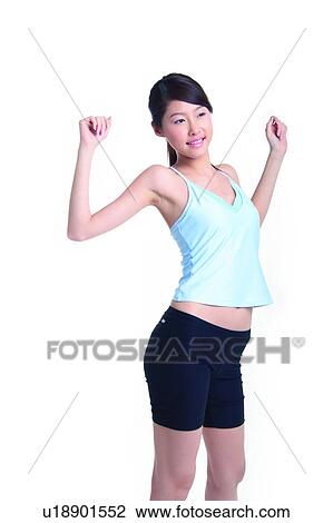Young woman standing and stretching View Large Photo Image Stock Image - Young woman standing and stretching. Fotosearch