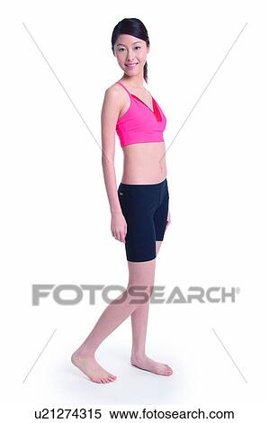 Young woman standing in side view, full length View Large Photo Image Stock Photography - Young woman standing in side view, full length. Fotosearch