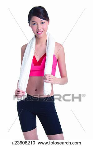 Young woman standing with towel on neck View Large Photo Image Stock Image - Young woman standing with towel on neck. Fotosearch