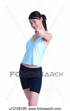 Young woman wearing tank top and pointing View Large Photo Image Stock Photo - Young woman wearing tank top and pointing. Fotosearch