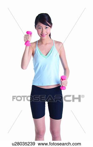 Young woman wearing tank top and lifting dumbbell, front view View Large Photo Image Stock Photo - Young woman wearing tank top and lifting dumbbell, front view. Fotosearch