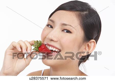 Portrait of Natural Young girl eating Strawberry View Large Photo Image Stock Image - Portrait of Natural Young girl eating Strawberry. Fotosearch