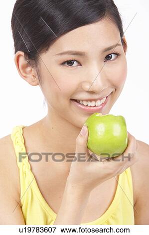 Portrait of Natural Young girl holding Apple, Smiling View Large Photo Image Stock Photo - Portrait of Natural Young girl holding Apple, Smiling. Fotosearch