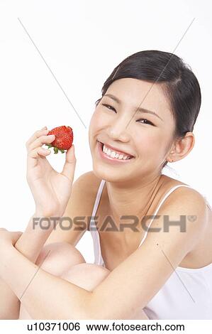 Portrait of Natural Young girl holding Strawberry, Smiling View Large Photo Image Stock Photograph - Portrait of Natural Young girl holding Strawberry, Smiling. Fotosearch