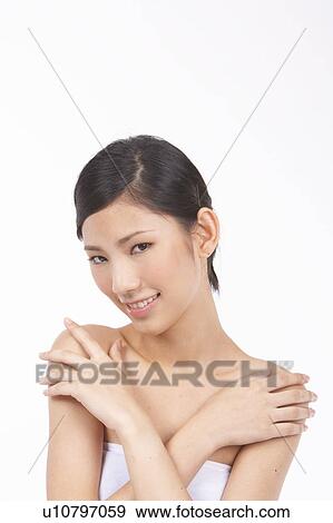 Portrait of Natural Young girl touching shoulder View Large Photo Image Stock Photo - Portrait of Natural Young girl touching shoulder. Fotosearch
