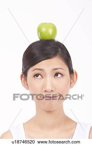 Portrait of Natural Young girl with an Apple on Her Head View Large Photo Image Stock Image - Portrait of Natural Young girl with an Apple on Her Head. Fotosearch