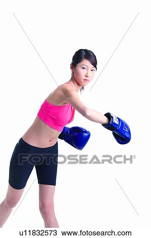 Stock Image - Young woman boxing. Fotosearch
