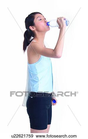 Stock Photo - Young woman drinking water. Fotosearch