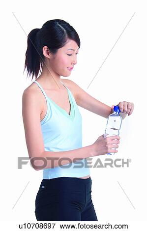Stock Photo - Young woman holding a bottle of water. Fotosearch