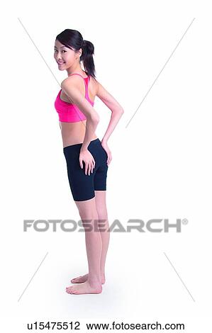 Young woman in sporty wear, standing, full length View Large Photo Image Stock Image - Young woman in sporty wear, standing, full length. Fotosearch