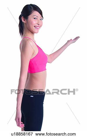 Stock Photo - Young woman smiling and welcoming someone. Fotosearch