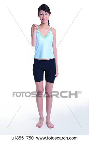 Young woman standing and pointing at you View Large Photo Image Stock Image - Young woman standing and pointing at you. Fotosearch