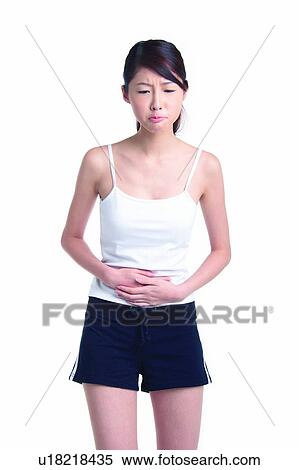 Young woman standing with hands on abdomen View Large Photo Image Stock Photography - Young woman standing with hands on abdomen. Fotosearch