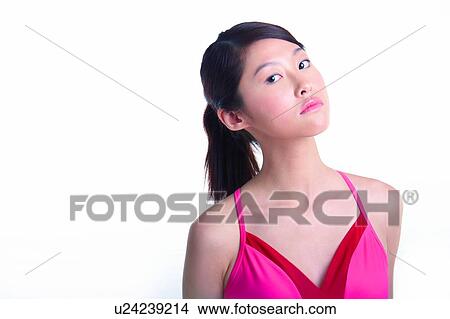 Picture - Young woman standing with ponyhair. Fotosearch