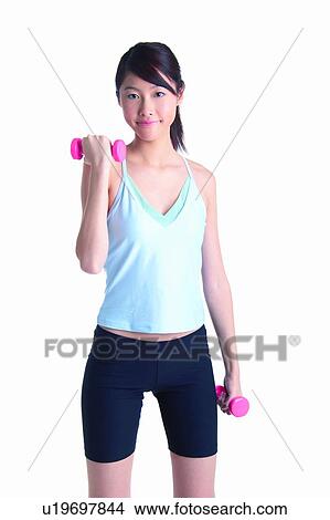 Young woman wearing tank top and lifting dumbbell, front view View Large Photo Image Picture - Young woman wearing tank top and lifting dumbbell, front view. Fotosearch