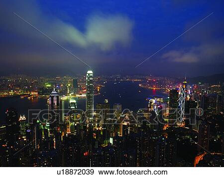 Stock Photo - China, Hong Kong, skyscrapers and harbor, night, aerial view. Fotosearch