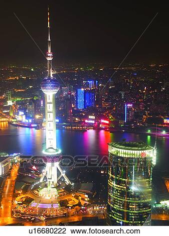 Stock Image - Oriental Pearl Tower, China, Shanghai, skyline across water, night. Fotosearch