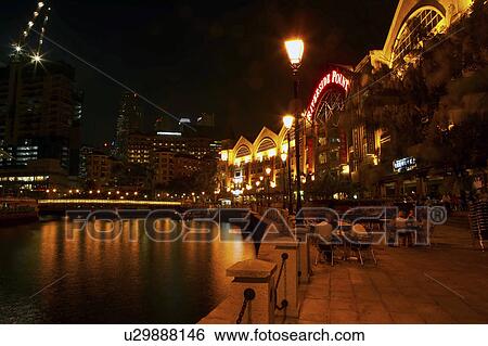 Stock Photograph - Riverside Point restaurants and cafes along Singapore River with Swissotel and Merchant Court.. Fotosearch