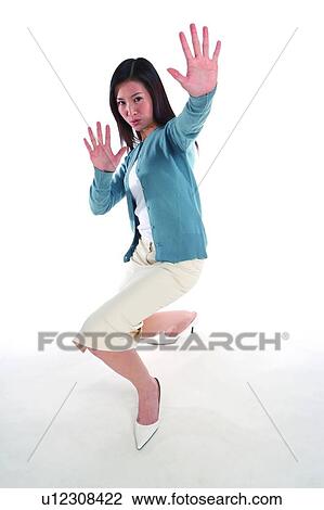 Young woman crouching with hands in front View Large Photo Image Stock Image - Young woman crouching with hands in front. Fotosearch