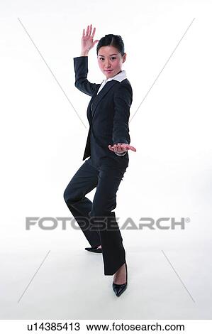 Stock Image - Young woman in business suit, accepting challenge. Fotosearch
