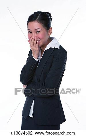 Young woman in business suit, covering mouth with hand, laughing View Large Photo Image Stock Image - Young woman in business suit, covering mouth with hand, laughing. Fotosearch