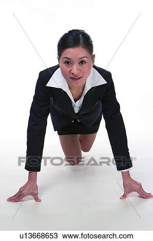 Young woman in business suit, hands on ground supporting body View Large Photo Image Stock Image - Young woman in business suit, hands on ground supporting body. Fotosearch