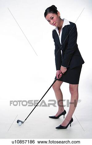 Young woman in business suit, holding golf club, full length View Large Photo Image Stock Photograph - Young woman in business suit, holding golf club, full length. Fotosearch