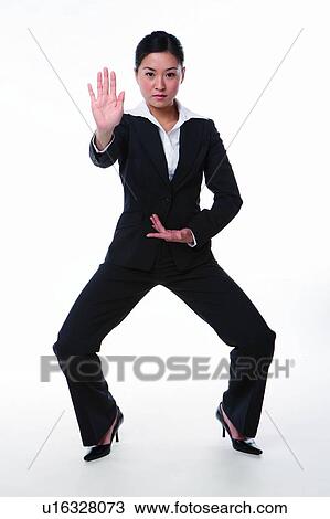 Young woman in business suit, in kung fu pose View Large Photo Image Stock Image - Young woman in business suit, in kung fu pose. Fotosearch
