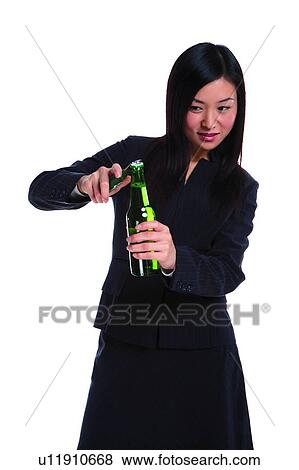 Young woman in business suit, opening bottle View Large Photo Image Stock Photo - Young woman in business suit, opening bottle. Fotosearch