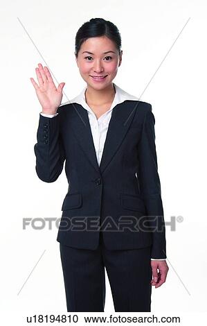 Young woman in business suit, raising hand, front view View Large Photo Image Stock Image - Young woman in business suit, raising hand, front view. Fotosearch