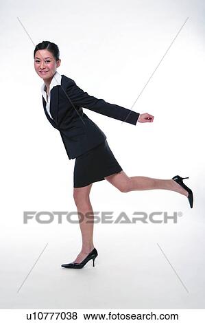 Young woman in business suit, running, side view, full length View Large Photo Image Stock Photo - Young woman in business suit, running, side view, full length. Fotosearch