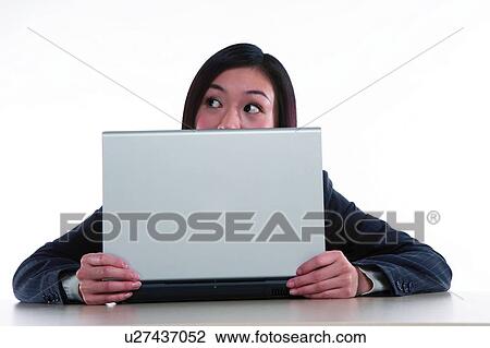 Young woman in business suit, sitting, holding notebook in front View Large Photo Image Stock Image - Young woman in business suit, sitting, holding notebook in front. Fotosearch