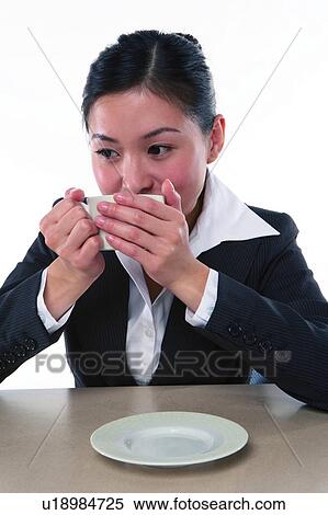 Young woman in business suit, sitting, having tea View Large Photo Image Stock Photography - Young woman in business suit, sitting, having tea. Fotosearch
