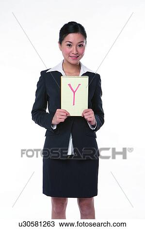 Young woman in business suit, standing, holding an notebook with "Y" marked on View Large Photo Image Stock Image - Young woman in business suit, standing, holding an notebook with "Y" marked on. Fotosearch