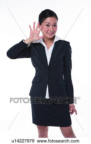 Stock Photo - Young woman in business suit, standing, raising five fingers. Fotosearch