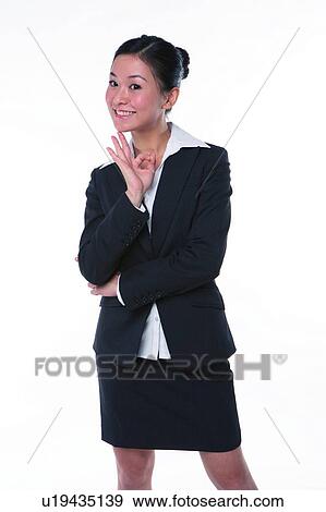 Stock Photo - Young woman in business suit, standing, raising three fingers. Fotosearch