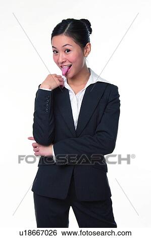 Stock Photograph - Young woman in business suit, sticking out tongue. Fotosearch