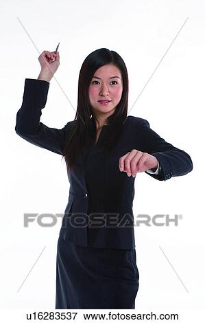 Young woman in business suit, throwing pen View Large Photo Image Stock Photo - Young woman in business suit, throwing pen. Fotosearch