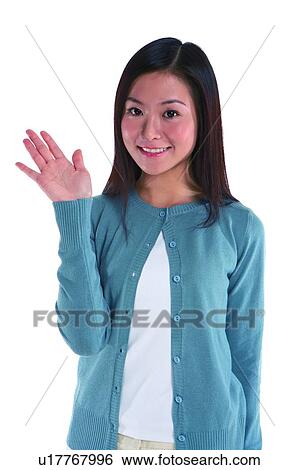 Young woman standing, hand raised View Large Photo Image Stock Photograph - Young woman standing, hand raised. Fotosearch