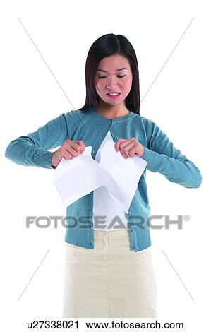 Young woman standing, tearing paper angrily View Large Photo Image Stock Image - Young woman standing, tearing paper angrily. Fotosearch