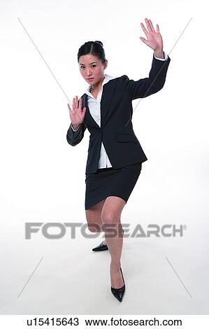 Young woman in business suit, bending knee View Large Photo Image Stock Image - Young woman in business suit, bending knee. Fotosearch
