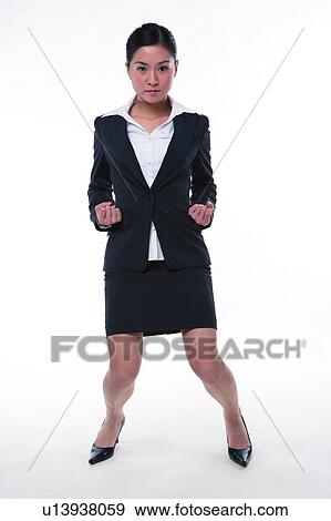 Young woman in business suit, bending knee, exercising View Large Photo Image Stock Photo - Young woman in business suit, bending knee, exercising. Fotosearch
