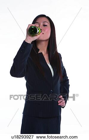 Stock Photo - Young woman in business suit, drinking. Fotosearch