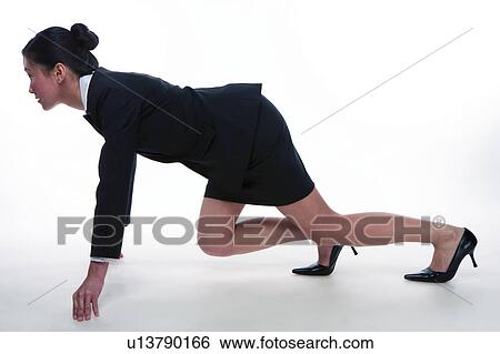 Young woman in business suit, hands on ground supporting body, side view View Large Photo Image Stock Photograph - Young woman in business suit, hands on ground supporting body, side view. Fotosearch