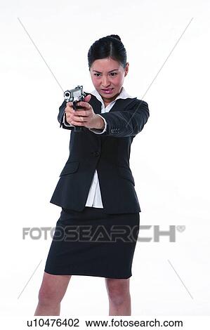 Young woman in business suit, holding gun, shooting, front view View Large Photo Image Stock Image - Young woman in business suit, holding gun, shooting, front view. Fotosearch