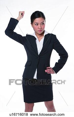 Stock Photo - Young woman in business suit, holding knife n in anger. Fotosearch