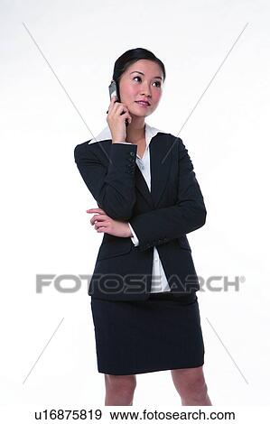 Stock Photo - Young woman in business suit, holding mobile phone. Fotosearch