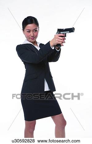 Young woman in business suit, holding gun, shooting View Large Photo Image Stock Photo - Young woman in business suit, holding gun, shooting. Fotosearch