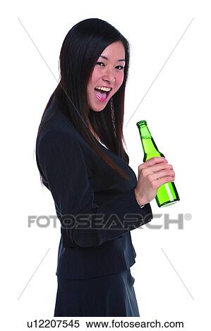 Stock Photography - Young woman in business suit, holding bottle of beer. Fotosearch