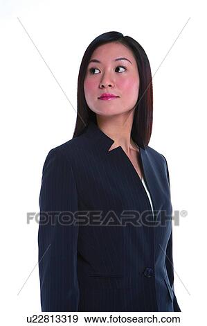 Stock Photo - Young woman in business suit, looking up. Fotosearch